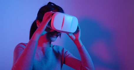 Wall Mural - Woman looking with virtual reality with red and blue light