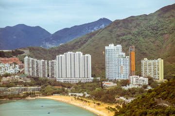 Aerial view of Repulse Bay - luxury residential area and famous beach in southern part in Hong Kong Island. Surrounding mountains on background. Toned image.