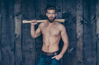© deagreez - Portrait of attractive sexy strong confident handsome manful brave serious strict brutal unshaven boy with mustache using carrying ax on shoulder isolated on wooden plank background steel