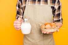 Close Up Cropped Photo Of Satisfied Farmer Showing Demonstrating Presenting Fresh Delicious Natural Eco Products From His Farm Brown Eggs And Jar Of Milk Isolated On Bright Background