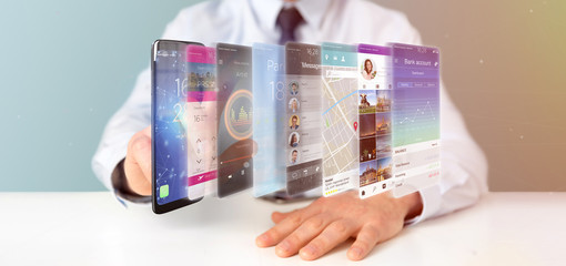 Wall Mural - Businessman holding 3d rendering app template on a smartphone