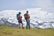© goodluz - Couple of hikers walking to the mountains