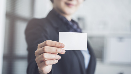 Woman holding the business card