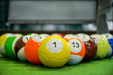 Wall Mural - Shot of foot pool balls standing on green table. Foot Pool is the hybrid combination of pool and soccer. Big billiard balls. 