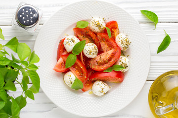 Wall Mural - Italian fresh tomato Caprese salad, mozzarella and Basil