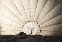 View To Inside Big Space Of White Expanding Hot Air Balloon (atmosphere Balloon) During Preparation Before Flight With Shadow Of Worker Man Holding Center During Blowing