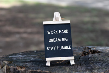Wall Mural - Inspirational quote - Work hard, dream big, stay humble, on black board.