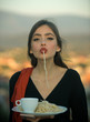 © Volodymyr - Chef woman with red lips eat pasta and drink coffee. chef, tasty breacfast or dinner with pasta and tea