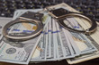 © yaroslav1986 - Handcuffs with money on the laptop keyboard. Top view