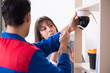 © Elnur - Client getting securty camera installed at home by contractor