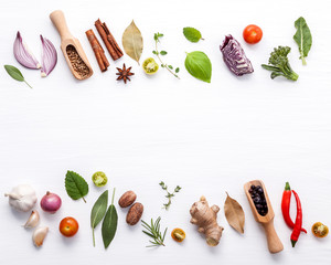 Wall Mural - Various fresh vegetables and herbs on white background.Ingredients for cooking concept sweet basil ,tomato ,garlic ,pepper and onion with flat lay..