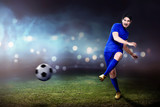 Fototapeta Młodzieżowe - Young asian footballer man kicking the ball