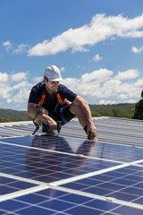 Wall Mural - Solar panel technician with drill installing solar panels