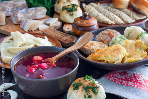 Fotografie, Obraz Traditional food in the Ukrainian cuisine - borsch, vareniki, bacon, broth, nalg