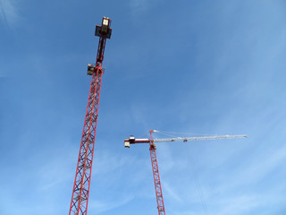 construction cranes on blue sky background