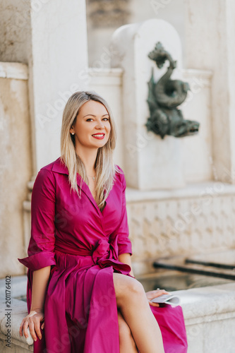 Poster Outdoor portrait of beautiful woman wearing pink dress