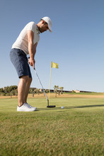 Golfer Hitting A Golf Shot In The Golf Course