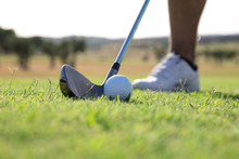Golf Ball And Golf Club On Golf Course