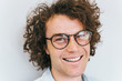 © Z A C - Closeup cropped portrait of handsome freckled positive male with healthy toothy smile, posing for advertisement, isolated on white wall with copy space for your information or content. People race