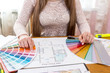 © RomanR - Designer showing colour swatch, choose colour for renovation