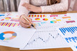 © RomanR - Woman manager working with business graphs and diagrams