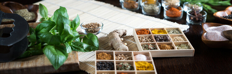 Variety of dry and fresh spices and herbs on table.