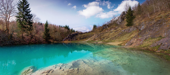 Wall Mural - Beautiful blue mountain lake. The Blue Colour is caused by former limestone mining. (Blauer See, Hüttenrode near Blankenburg, National Park Harz in Germany