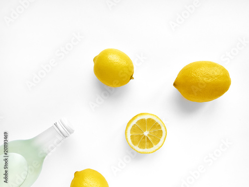 Download Lemonade In Bottle Transparent Glass Bottle With Lemonade Three Whole Lemons And One Lemon S Half Are Lying On White Background Photo Mockup In Top View With Copy Space Stock Photo Adobe