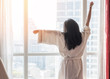 © Chinnapong - Happy life quality balance concept with young girl take it easy lifestyle waking up in weekend morning having some rest relaxing in comfort city hotel room enjoying world lazy day