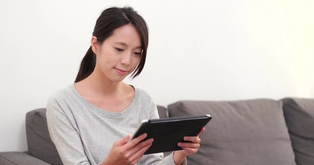 Sticker - Woman watching on digital tablet computer at home