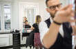 © innervisionpro - Mirror reflection of hairdresser preparing customer for hair cut
