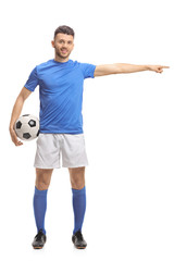 Canvas Print - Soccer player holding a football and pointing