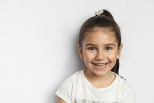 Portrait Of Happy Cute Brunette Child  Girl On White Background