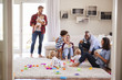 © Monkey Business - Adult friends with toddlers socialising in sitting room