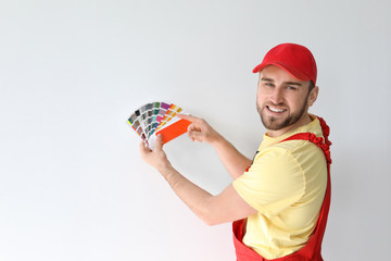 Poster - Male decorator with color palette on white background