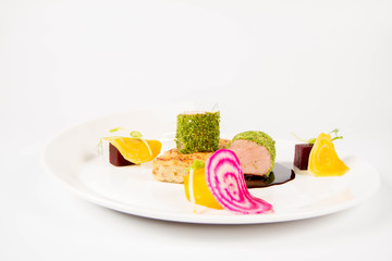 Sticker - Roast pork tenderloin with crispy potato bread, marinated beetroots and green pepper sauce on a plate on a white background