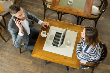 Young businees couple in cafe working