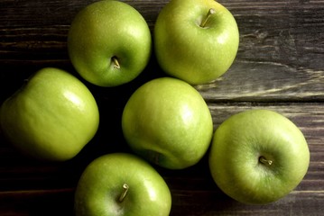 Wall Mural - Green apples on a wood board