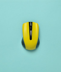 Wall Mural - wireless mouse isolated on a blue pastel background. top view, minimalist trend.