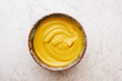 Delicious homemade English mustard in bowl top view
