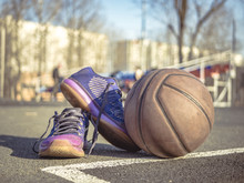 Basketball Shoes And Ball On The Court Outside