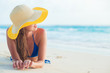 © el.rudakova - portrait of young long haired woman in sun hat relaxing at beach in the evening