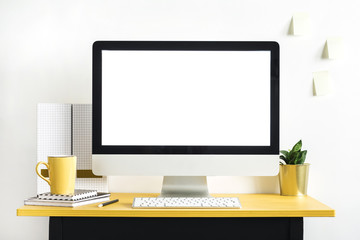 Concept of mock up computer screen in the modern, stylish office interior. Creative desk of freelancer. Black and yellow desk. 