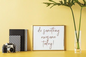 Creative desk with mock up poster frame and notebooks. Modern and minimalistic concept of desk.