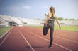 © Kris Tan - Fitness sport woman stretching herself before running in the morning.