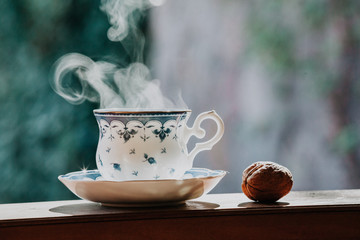 Elegant tea cup and walnut on shelf