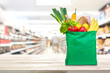 Shopping bag with food and groceries on the table in supermarket