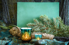 Christmas Arrangement In Teal Tones With Candles, Spruce Bough And BOHO Styling In A Horizontal Format.  A Chalkboard Is Included For Your Message