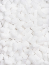 Vertical Filler Packing Background. Packaging Foam Pellets Texture, Top View, Close-up. Polystyrene, White Styrofoam Packing Peanuts Used To Prevent Damage To Fragile Objects During Shipping