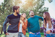 © Mediteraneo - Group of young people walking through park. Friends having fun outdoor